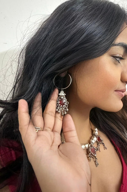 Woman wearing a vintage silver earring with intricate designs