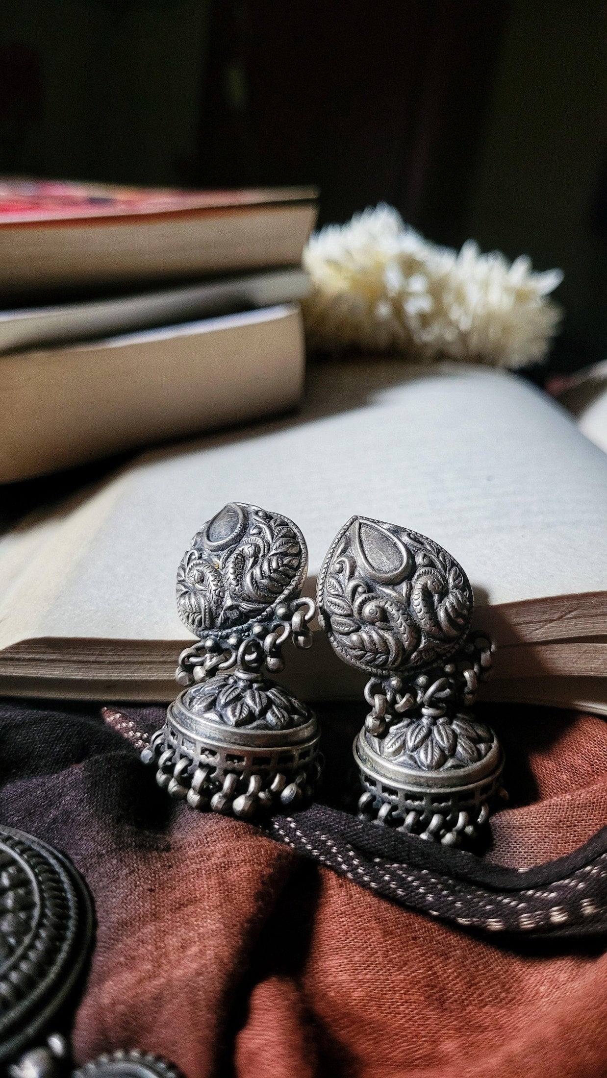 Side view of Anvi Jhumka in pure silver with handcrafted detailing