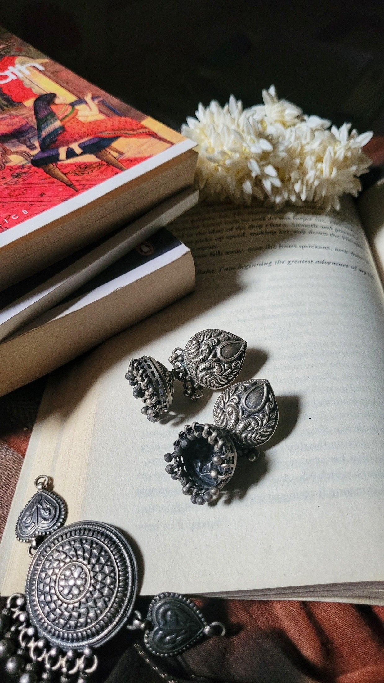 Side view of Anvi Jhumka in pure silver with handcrafted detailing