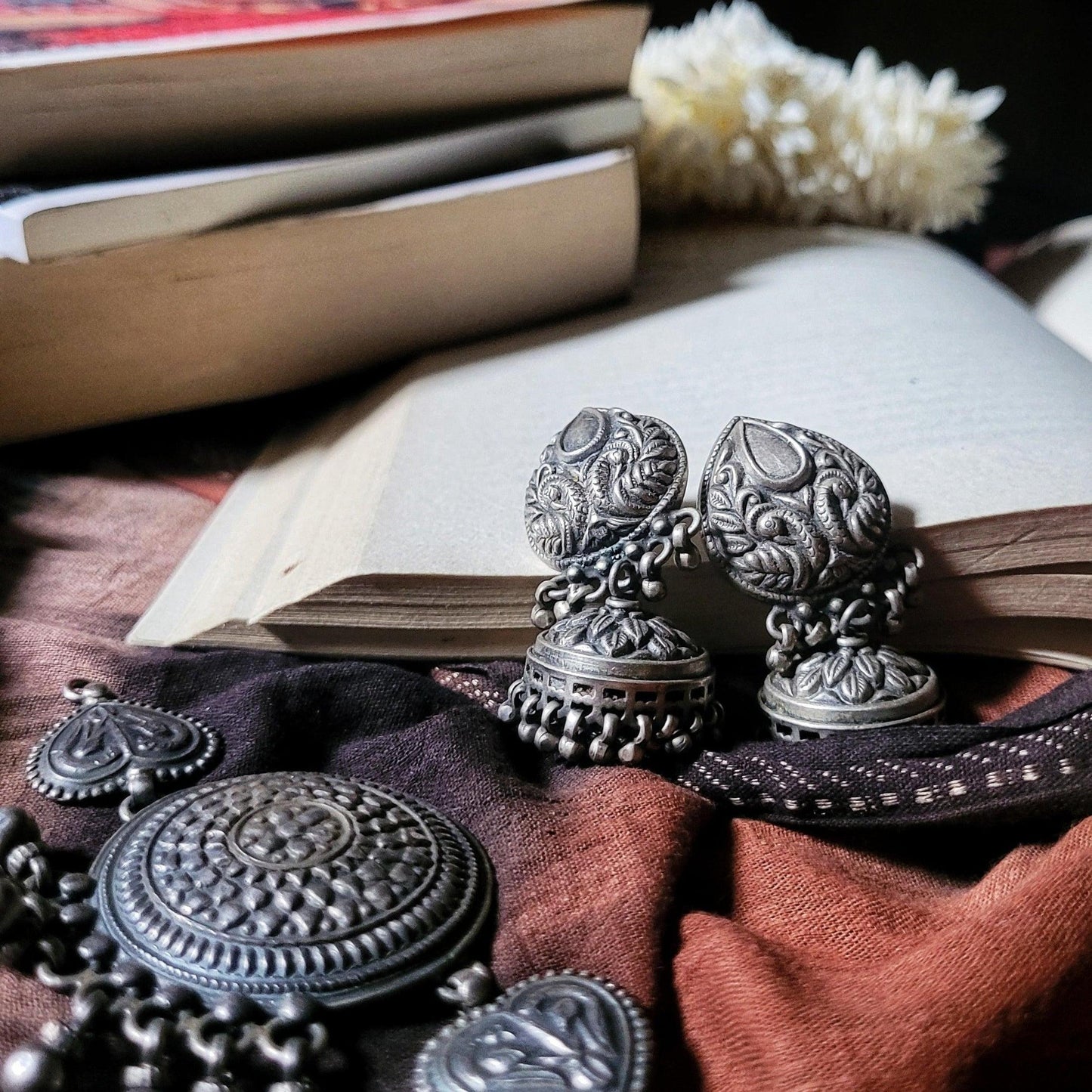 Side view of Anvi Jhumka in pure silver with handcrafted detailing