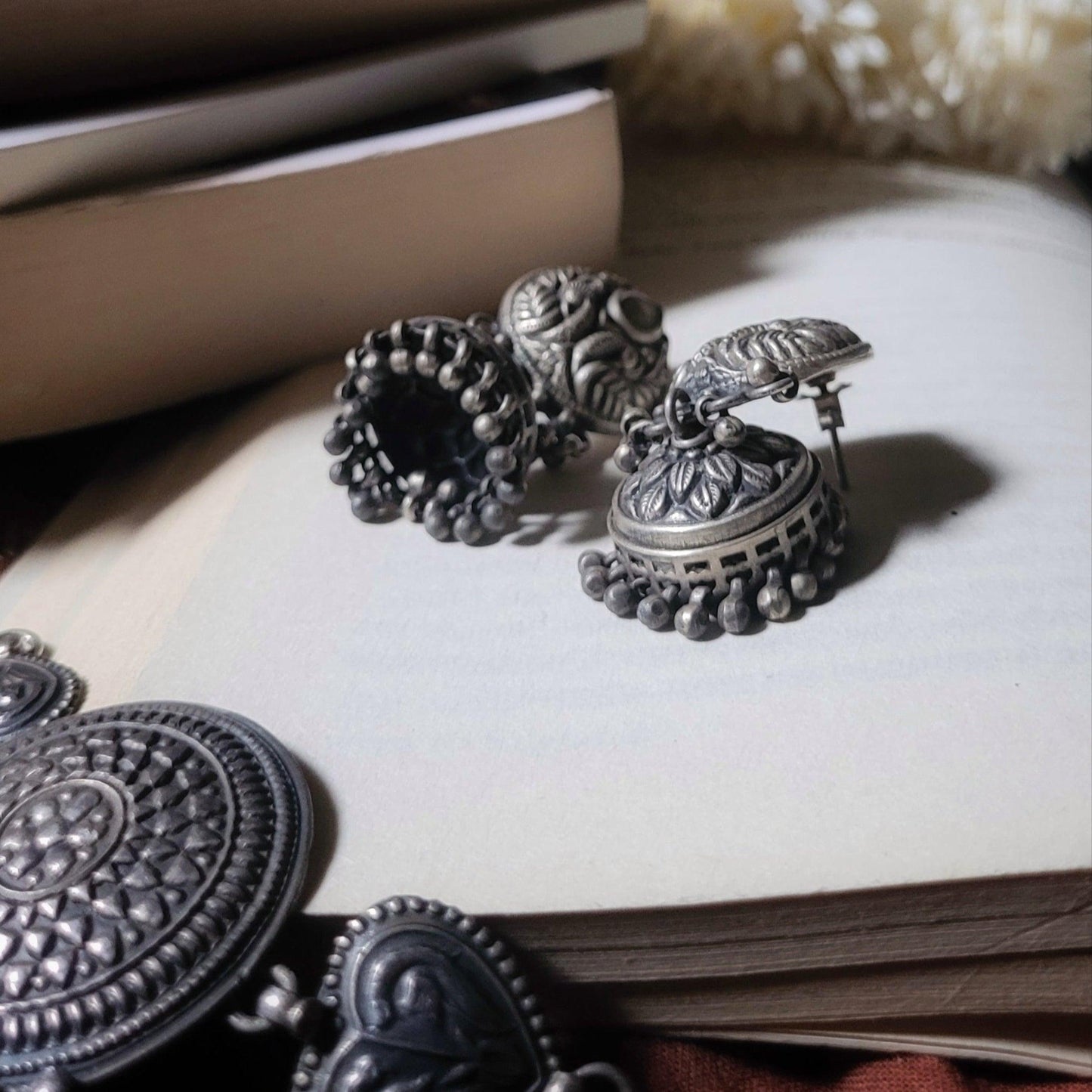 Side view of Anvi Jhumka in pure silver with handcrafted detailing