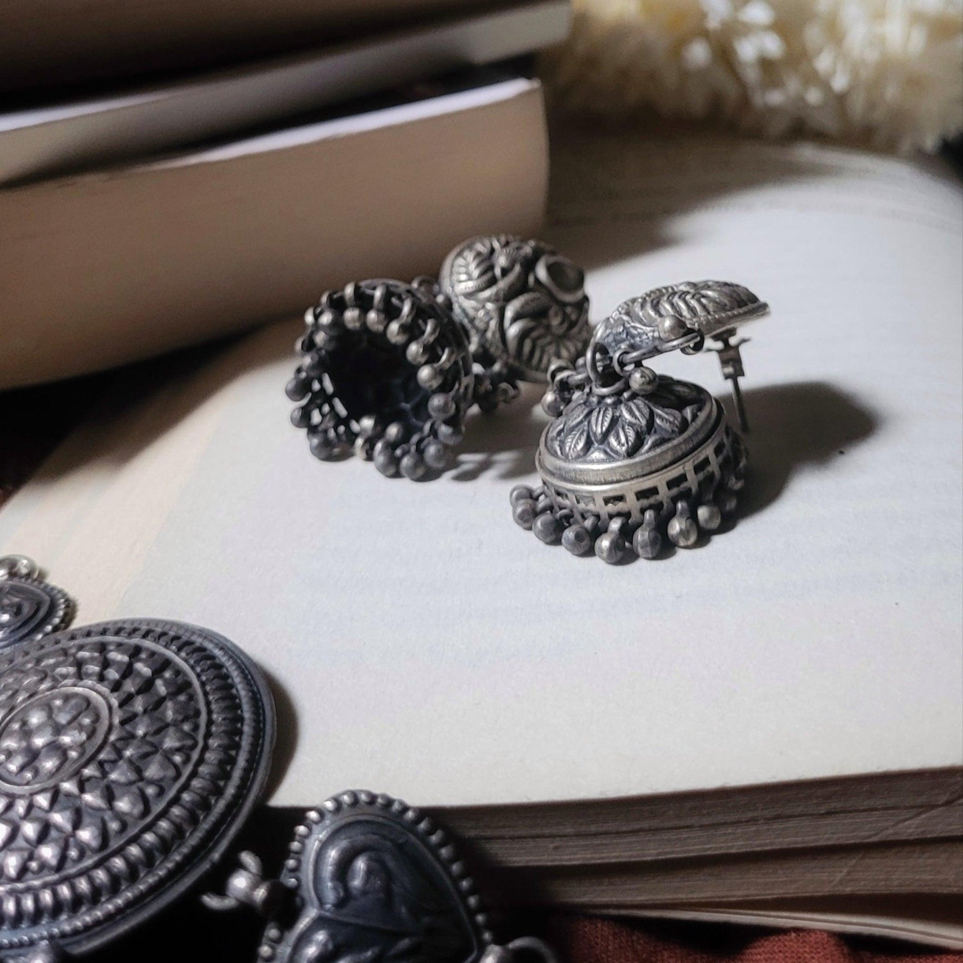 Side view of Anvi Jhumka in pure silver with handcrafted detailing
