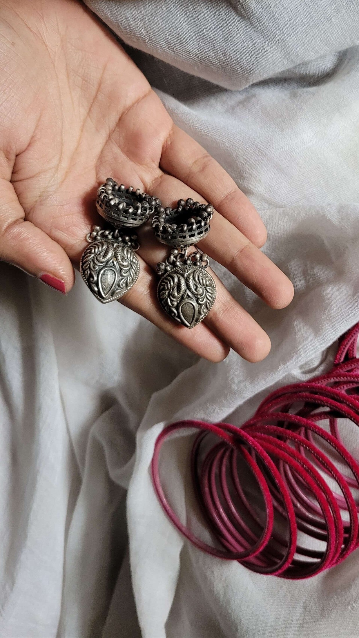 Side view of Anvi Jhumka in pure silver with handcrafted detailing