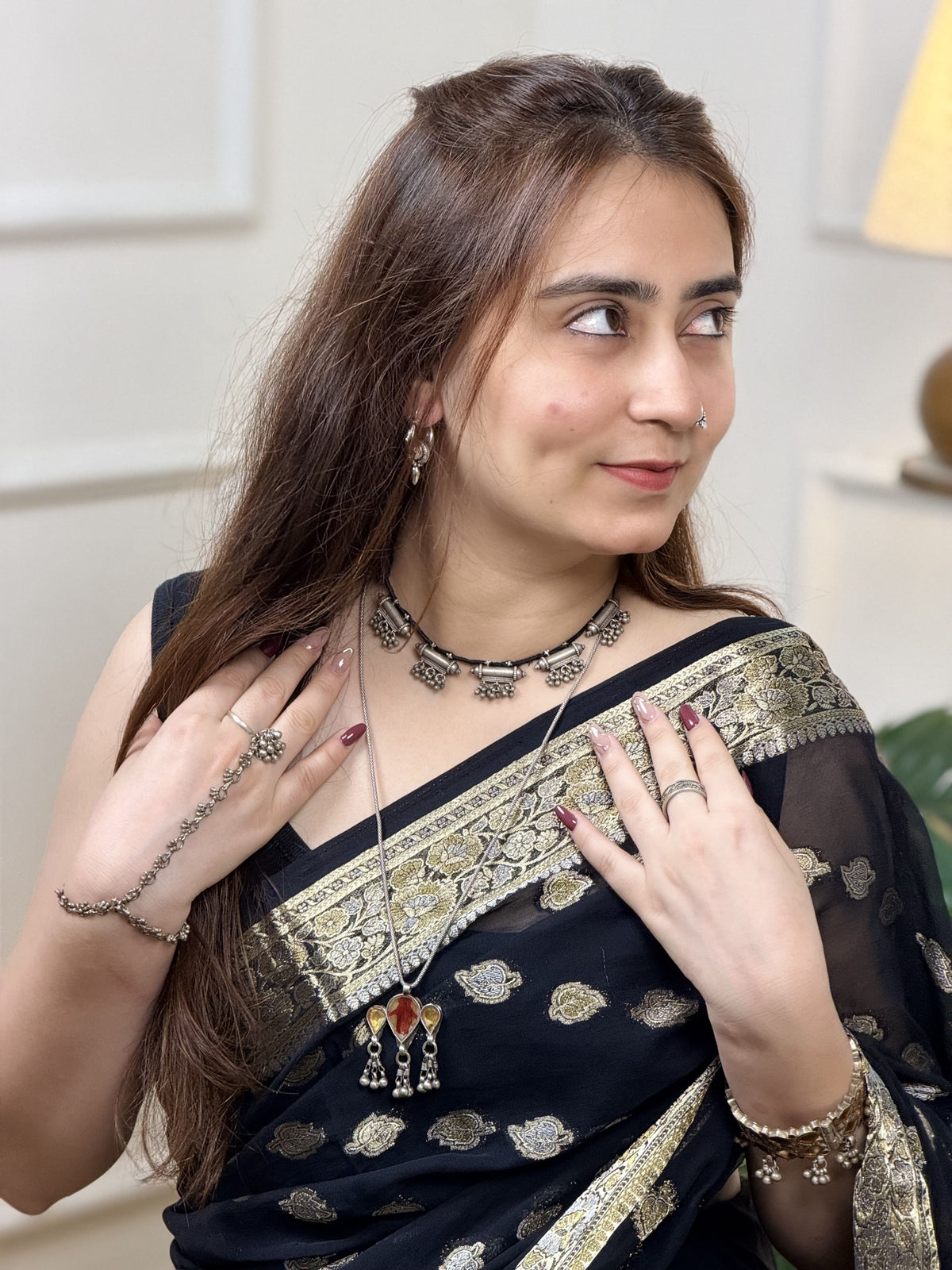 Vintage silver necklace with five taweez pendants on black dori — each with geometric embossing and three sets of three ghungroo clusters. Protective, ornate, heirloom. Shop Sadabahaar Jewelry.