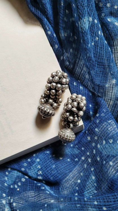Side view of Bandhan Earrings in pure silver with handcrafted detailing