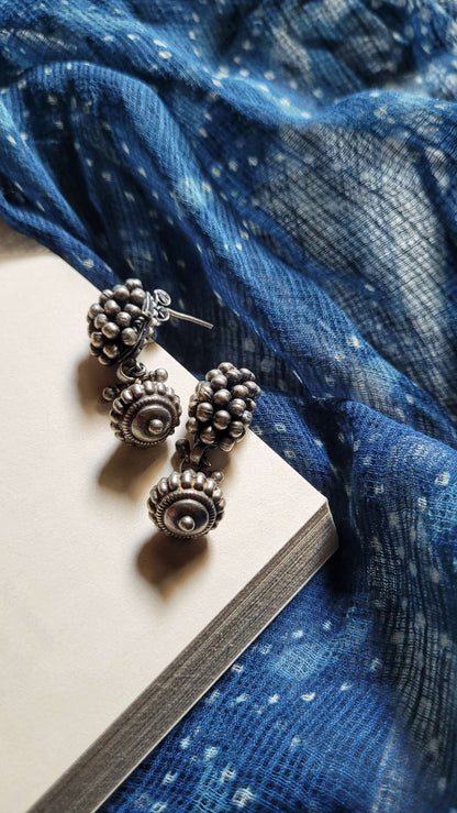 Side view of Bandhan Earrings in pure silver with handcrafted detailing