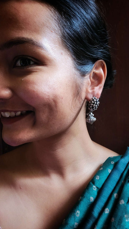 Side view of Bandhan Earrings in pure silver with handcrafted detailing