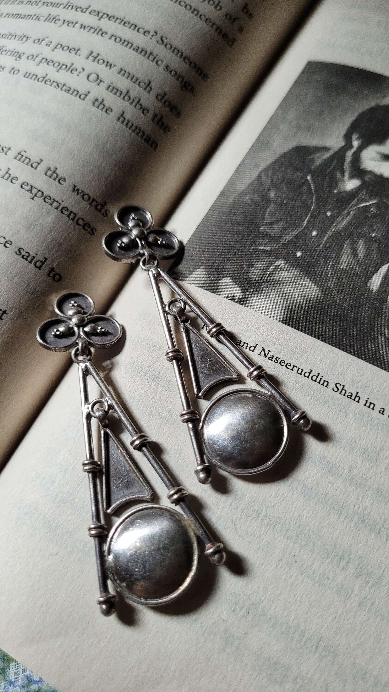 Big Ben Silver earrings on an open book with a black and white photo in the background