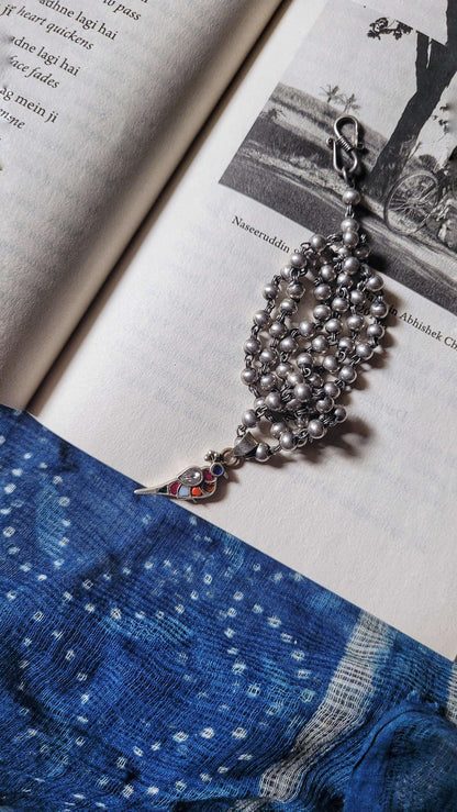 Side view of Bulbul Pendant in pure silver with handcrafted detailing