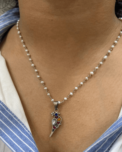 Side view of Bulbul Pendant in pure silver with handcrafted detailing