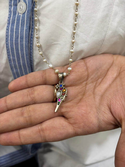 Side view of Bulbul Pendant in pure silver with handcrafted detailing