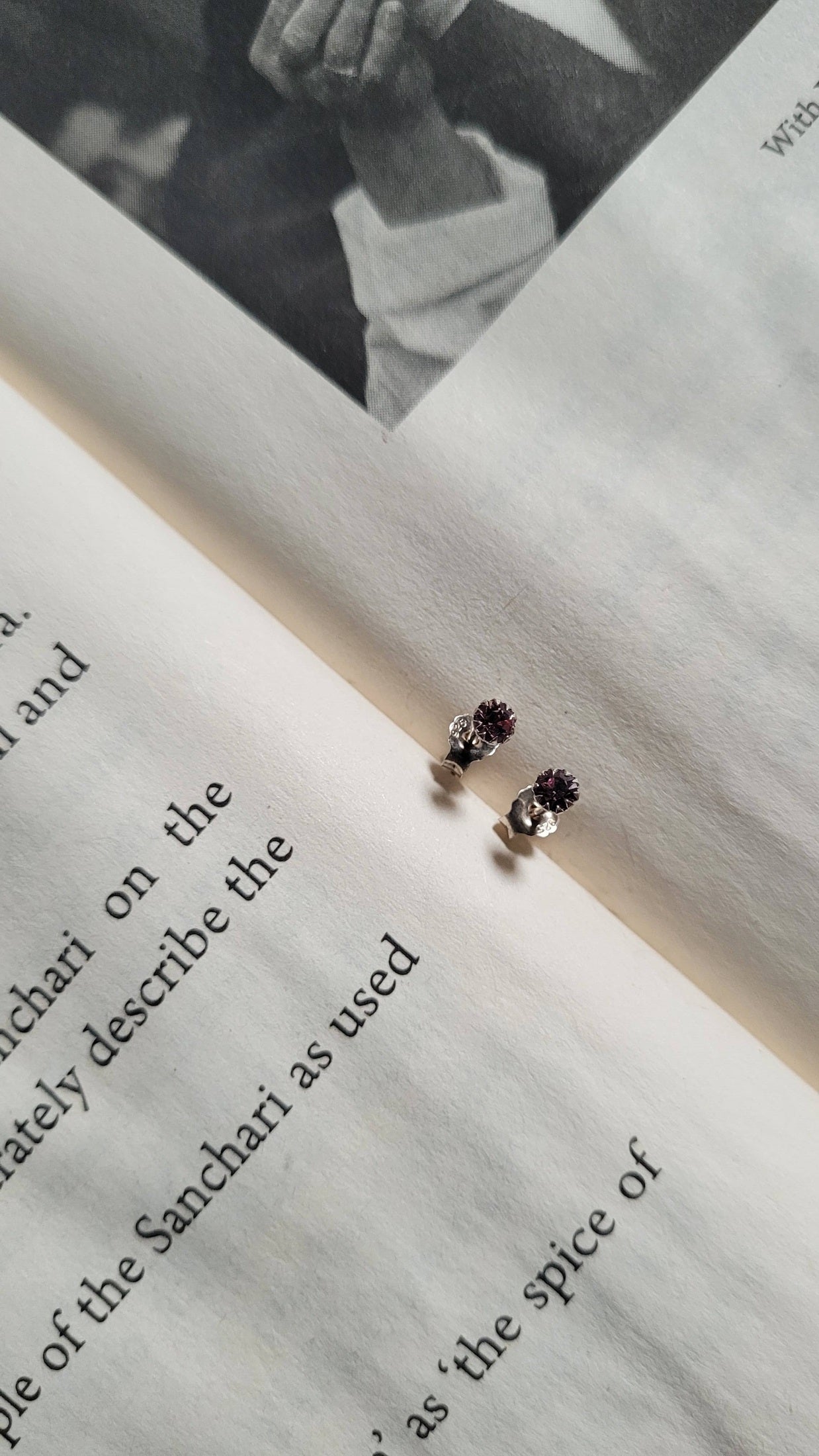 Pair of Chamkeeli earrings on an open book