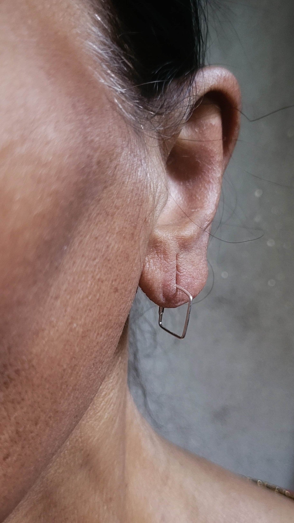 Side view of Chaukor Hoops in pure silver with handcrafted detailing