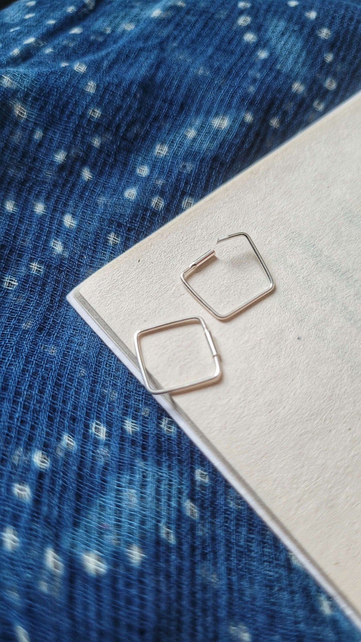 Side view of Chaukor Hoops in pure silver with handcrafted detailing