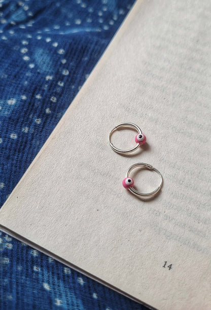 Side view of Cheshm Nazar Hoops in pure silver with handcrafted detailing