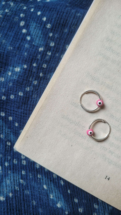 Side view of Cheshm Nazar Hoops in pure silver with handcrafted detailing