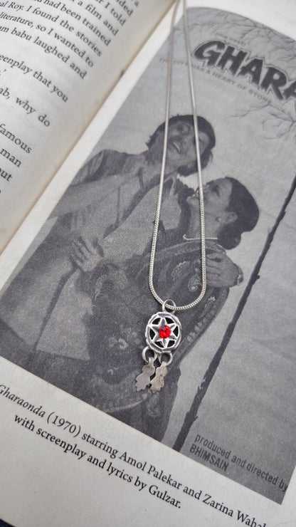 Necklace with a red star pendant on an open book