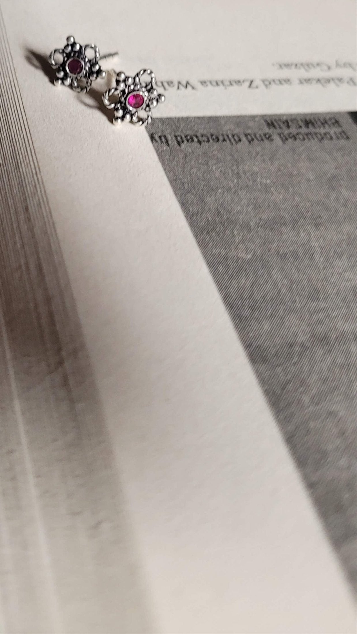 Close-up of a book with Eros Studs on a blue textured fabric background