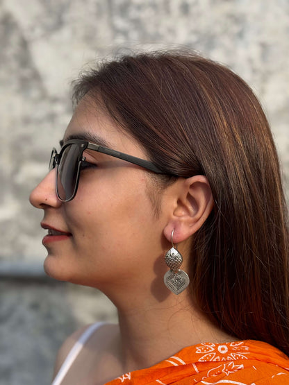 Side view of Hilsa Earrings in pure silver with handcrafted detailing