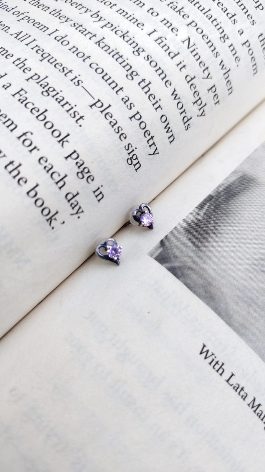 Purple earrings on an open book