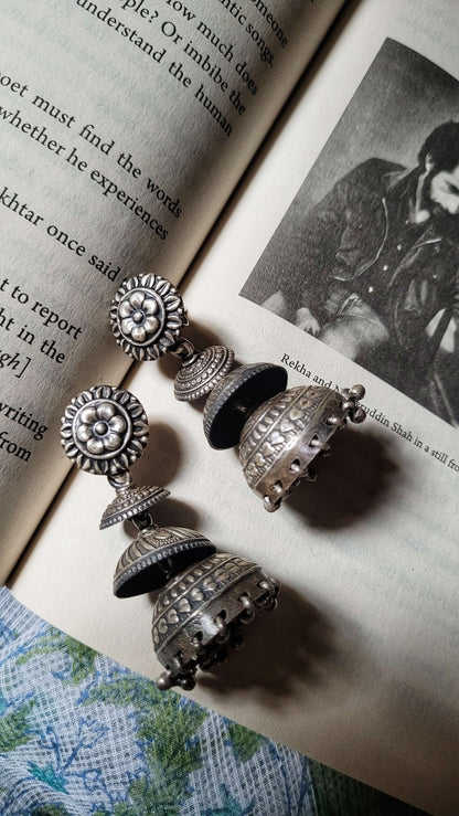 Side view of Ithalaati Jhumkas in pure silver with handcrafted detailing