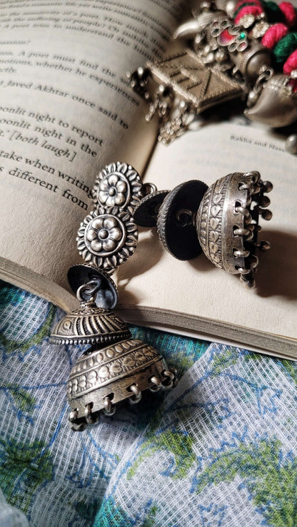Side view of Ithalaati Jhumkas in pure silver with handcrafted detailing