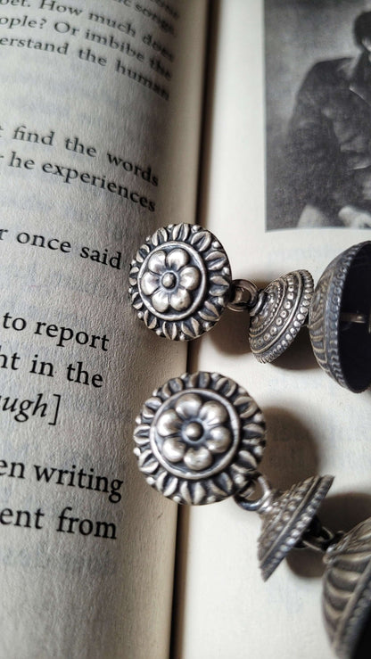 Side view of Ithalaati Jhumkas in pure silver with handcrafted detailing