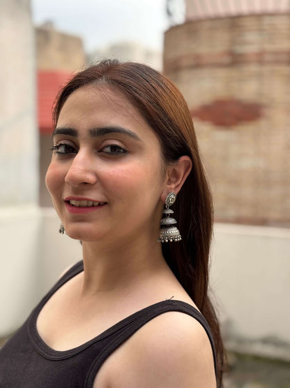 Side view of Ithalaati Jhumkas in pure silver with handcrafted detailing