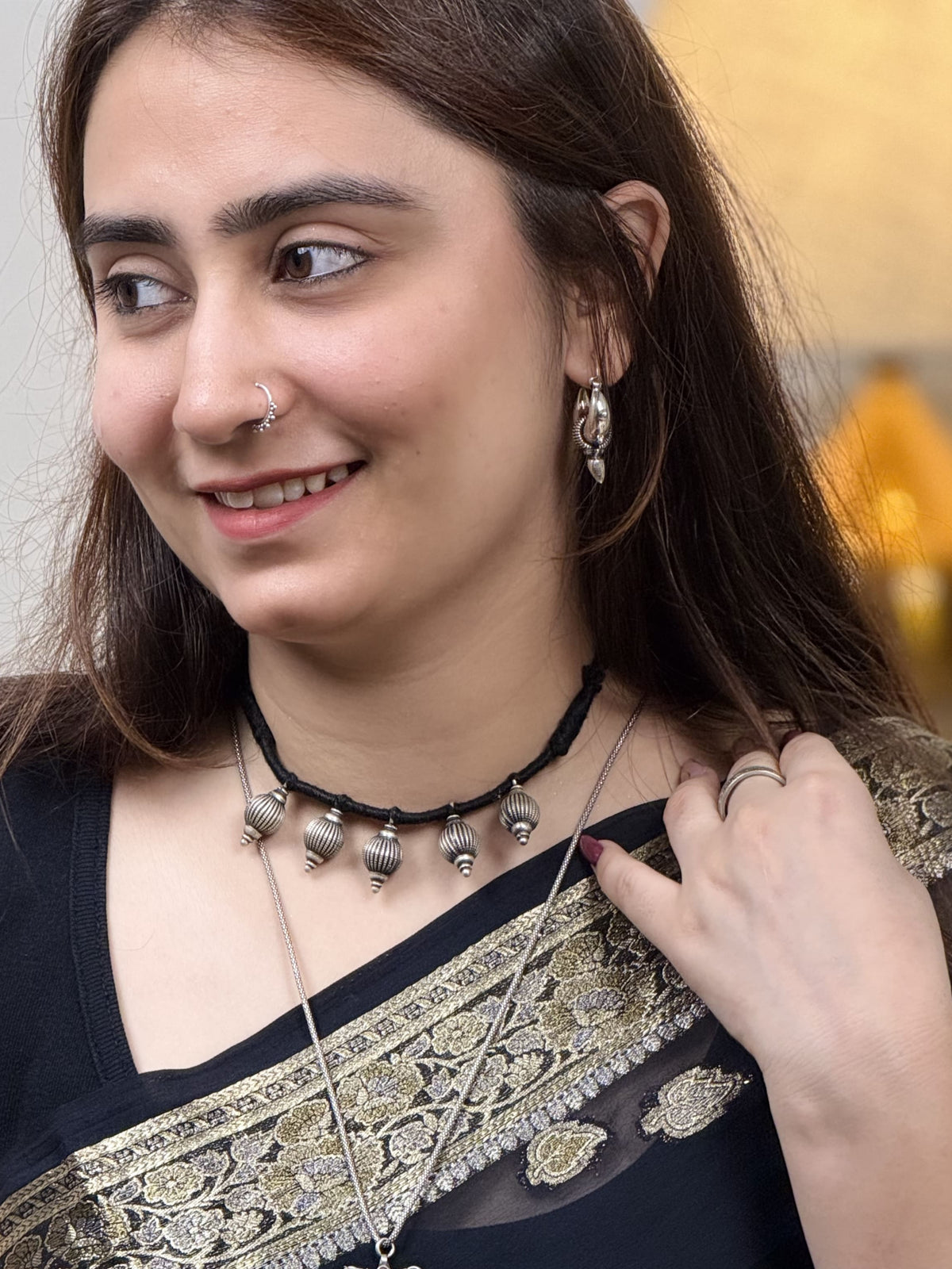 92.5 silver necklace with five 3D kalash-inspired beads, geometric embossed lines, three raised dots at base, on black dori. Minimalist, sacred-inspired, daily wear. Shop Sadabahaar Jewelry.