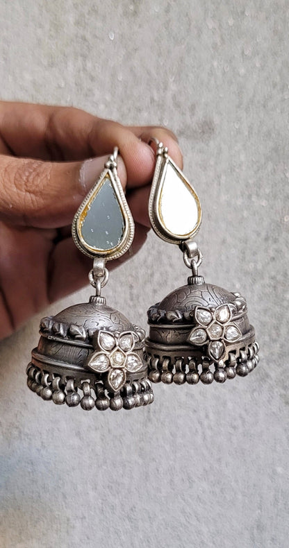 Side view of Kapaas Jhumka in pure silver with handcrafted detailing