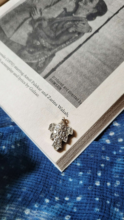 Side view of Katla Pendant in pure silver with handcrafted detailing