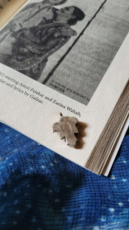 Side view of Katla Pendant in pure silver with handcrafted detailing