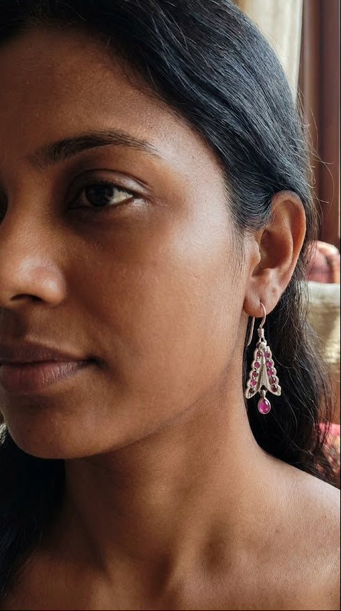 Close-up of a woman wearing Sadabahaar Jewelry arrings with a blurred background