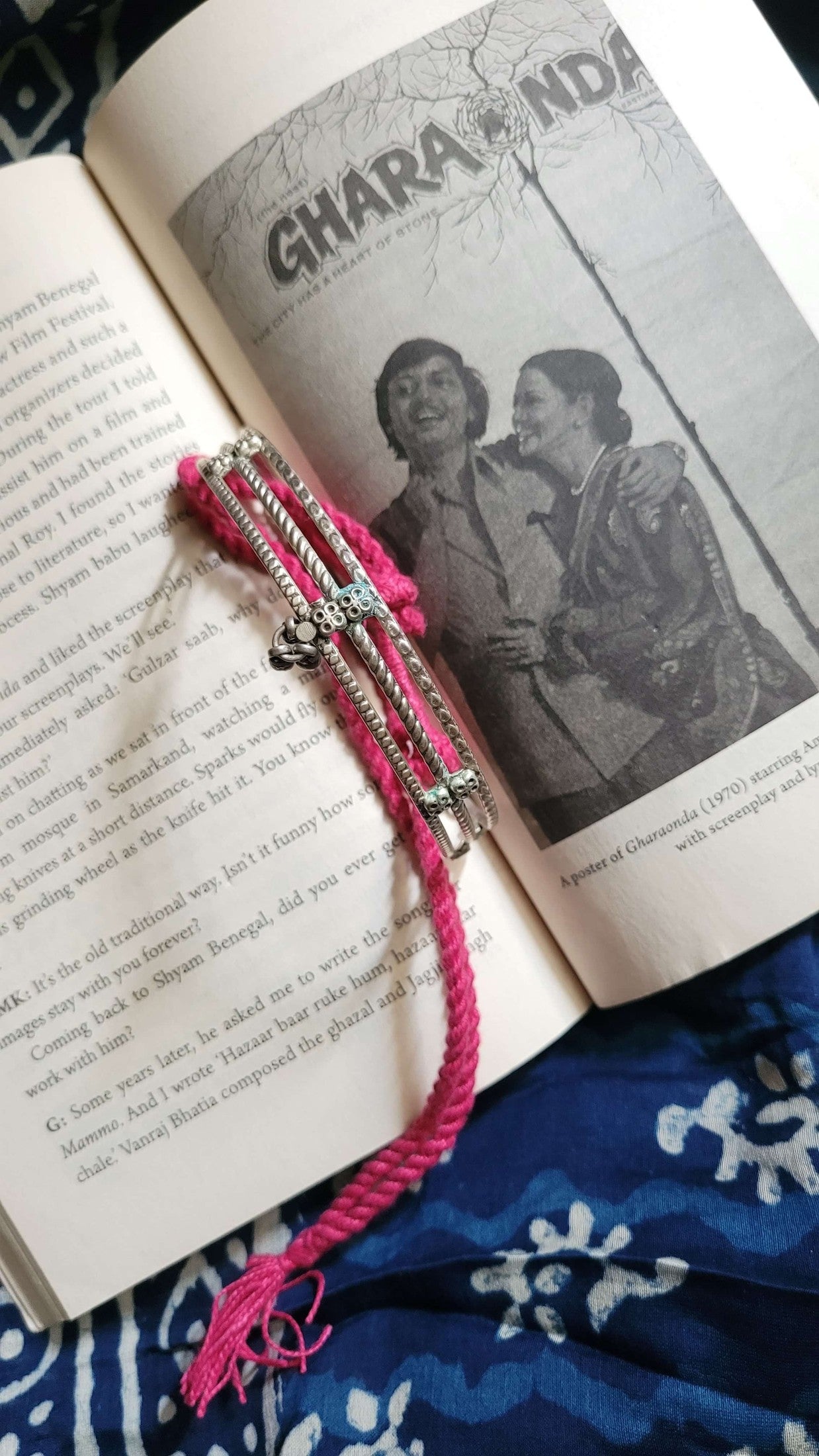 Kosha Vintage Choker with pink tassel on an open book