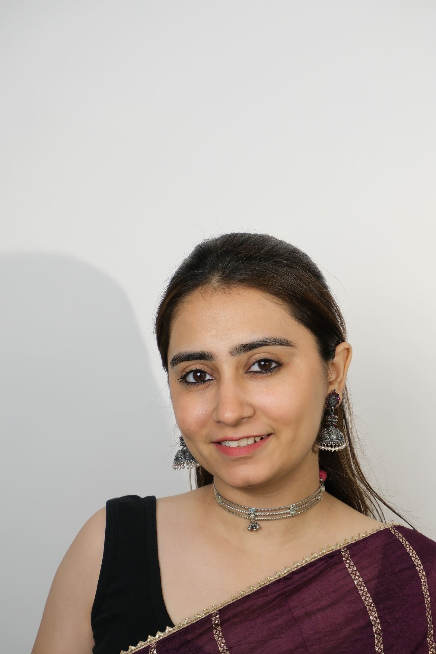 Woman wearing a traditional outfit with a plain background