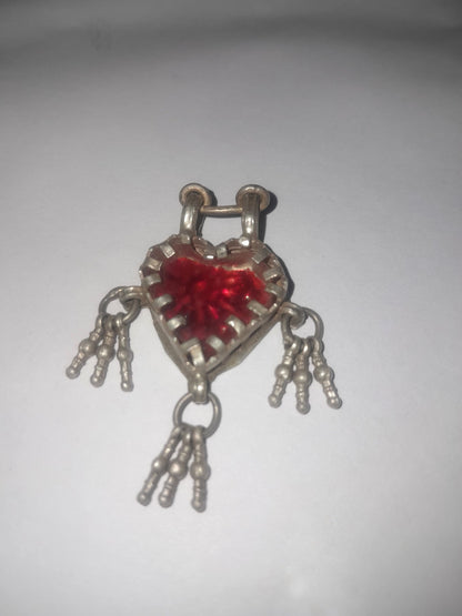 Red heart-shaped lock charm with silver chain on a white background
