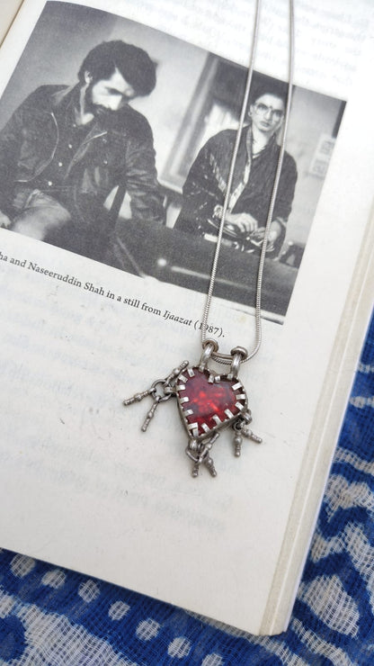 Necklace with a heart-shaped pendant on a book