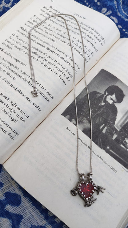 Necklace with a red pendant on an open book