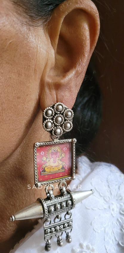 Side view of Mangalmurti Earrings in pure silver with handcrafted detailing