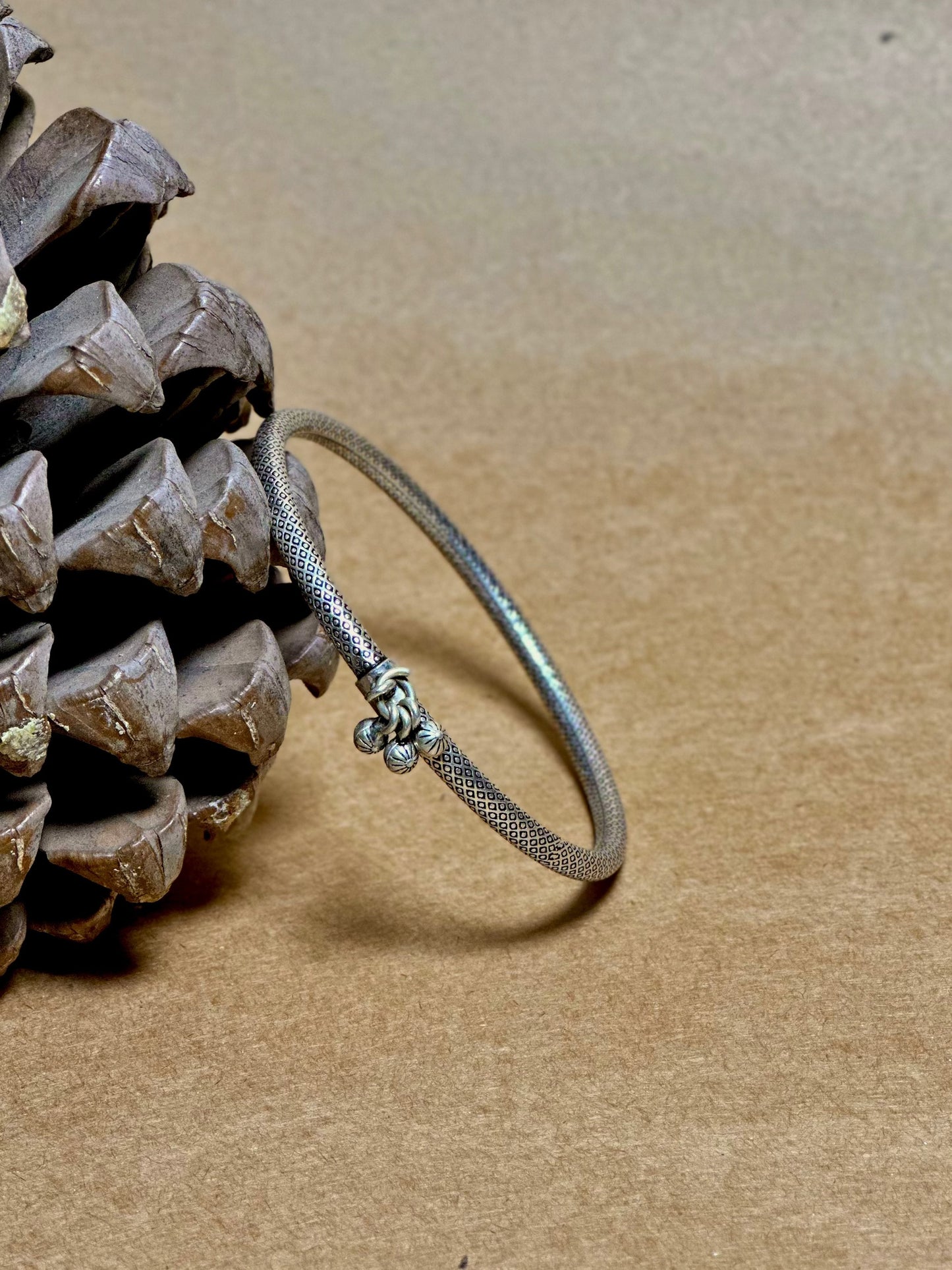 Side view of Manushi Leg Kada in pure silver with handcrafted detailing