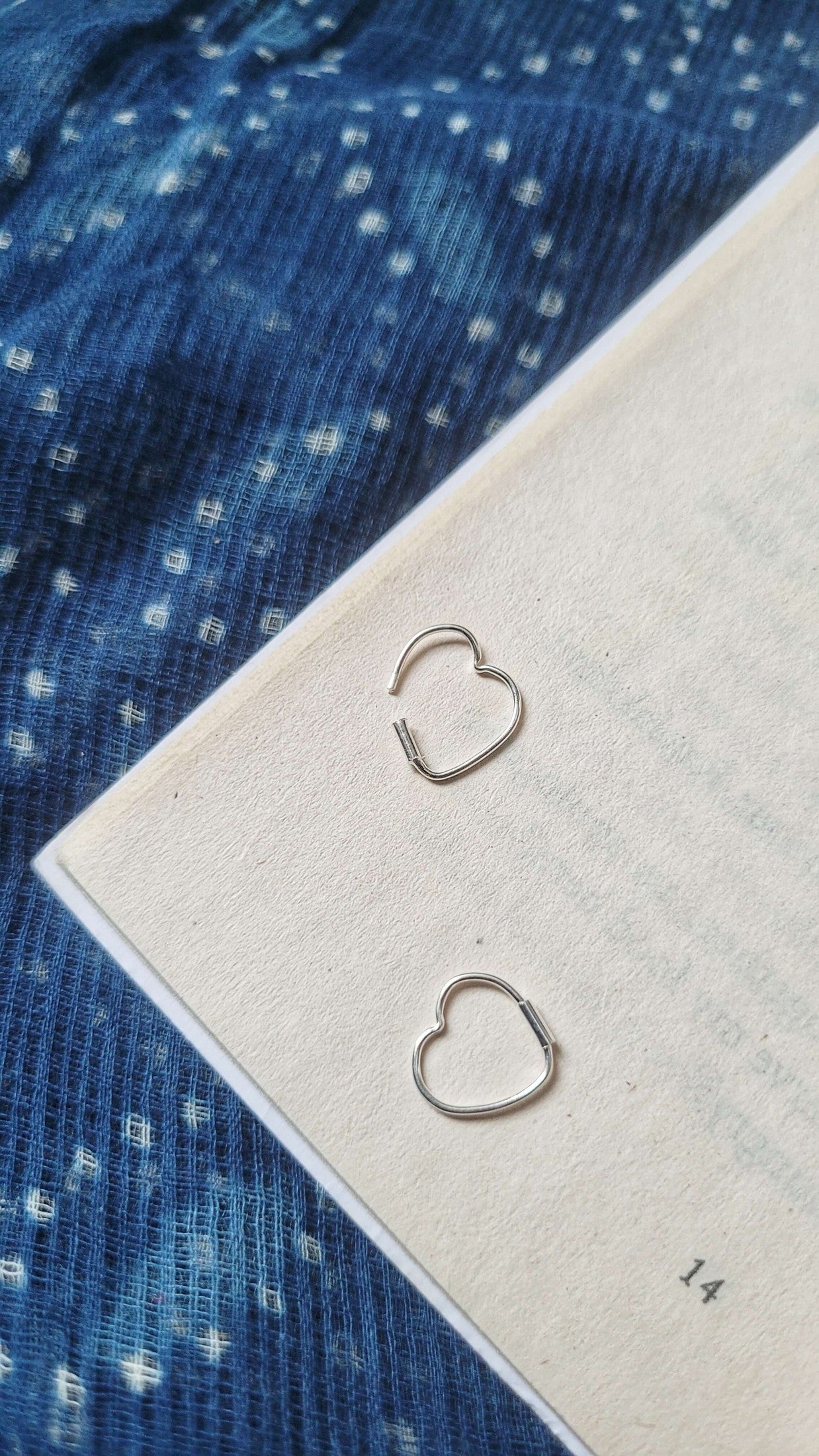 Side view of Masoom Heart Hoops in pure silver with handcrafted detailing