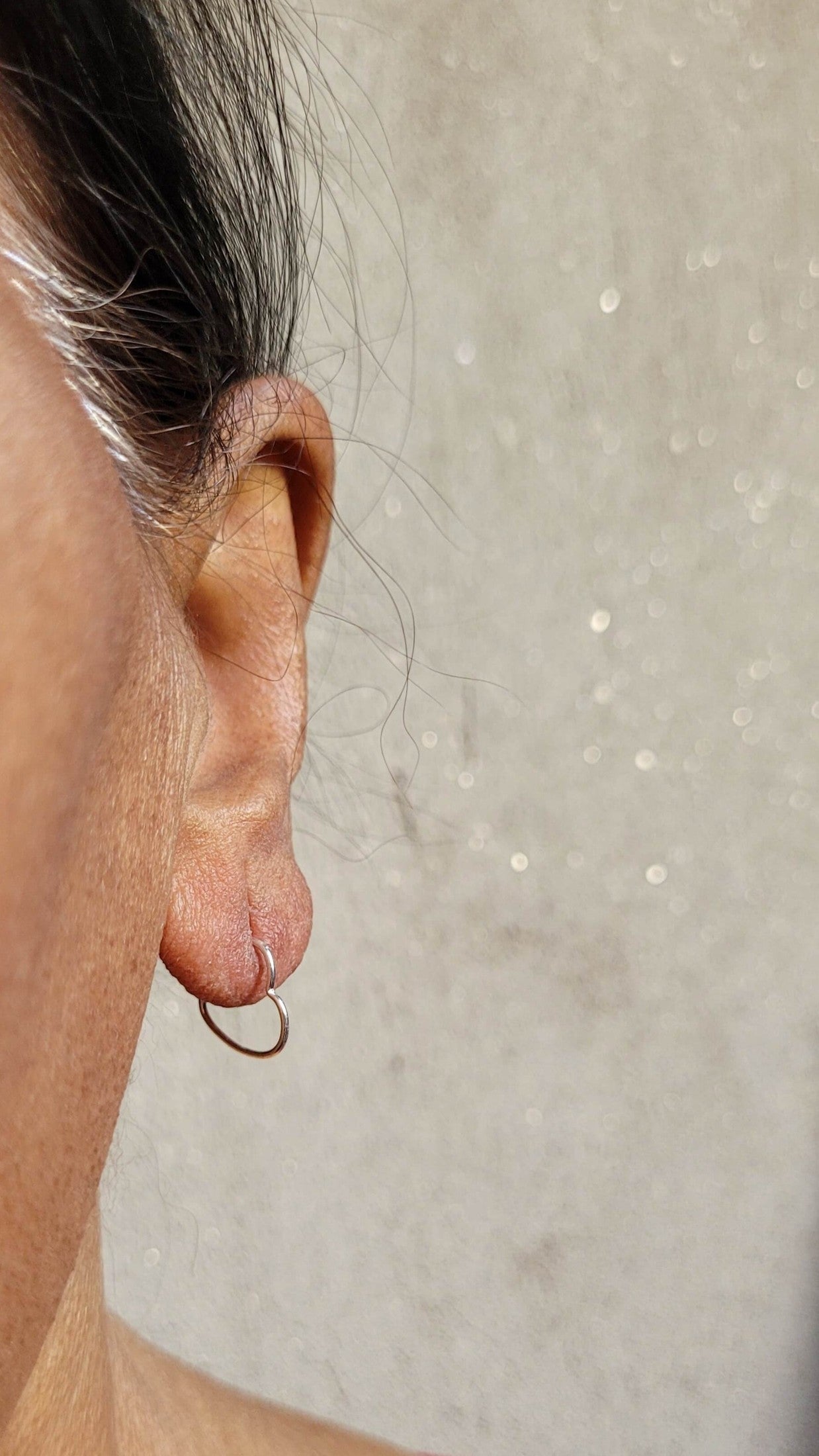 Side view of Masoom Heart Hoops in pure silver with handcrafted detailing