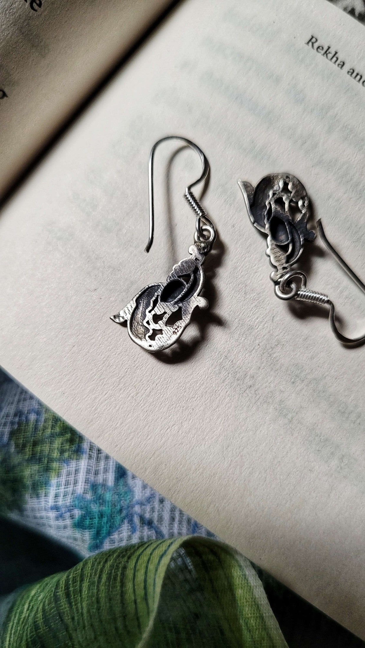 Side view of Mayil Earrings in pure silver with handcrafted detailing