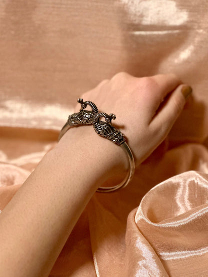 Side view of Mayurmukhi Kada in pure silver with handcrafted detailing