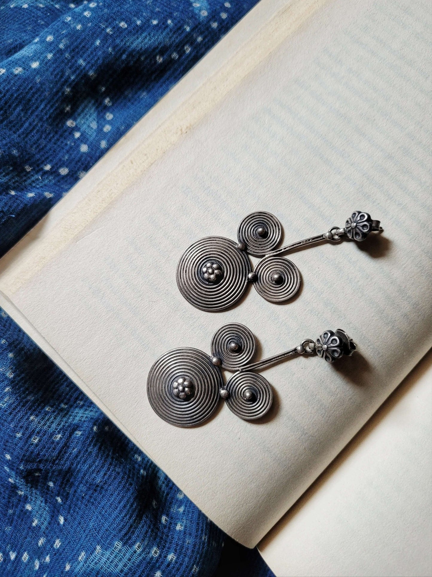 Side view of Mickey Earrings in pure silver with handcrafted detailing