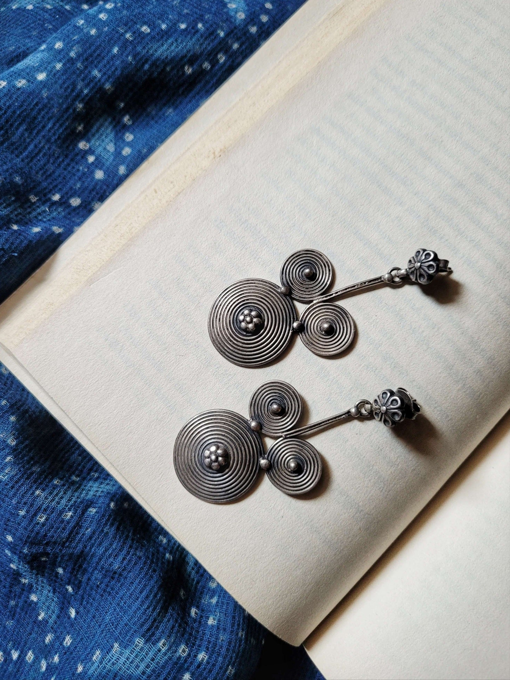 Side view of Mickey Earrings in pure silver with handcrafted detailing