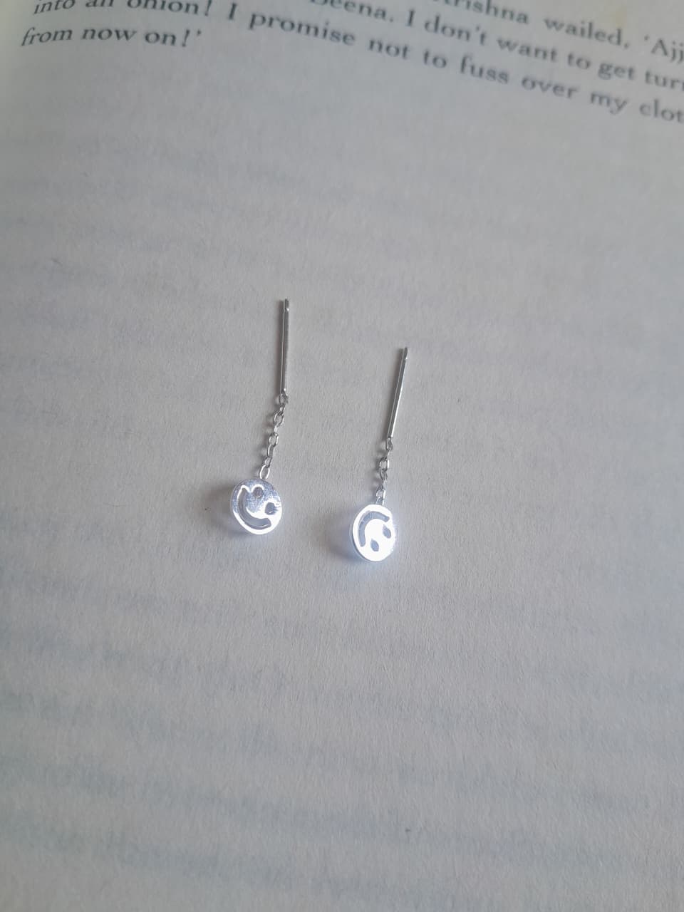92.5 silver sui dhaaga earrings with a cut-out silver smiley face on linear chain. No back needed. The earring that reminds you to smile back at life. Cute, lightweight, daily wear. Shop Sadabahaar Jewelry.
