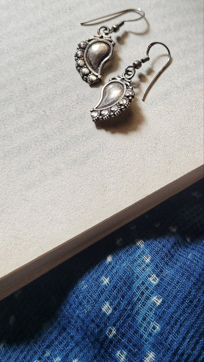 Side view of Paakhi Earrings in pure silver with handcrafted detailing