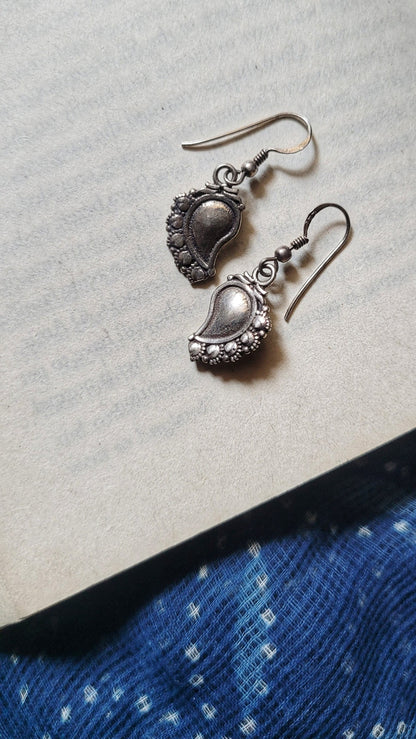 Side view of Paakhi Earrings in pure silver with handcrafted detailing