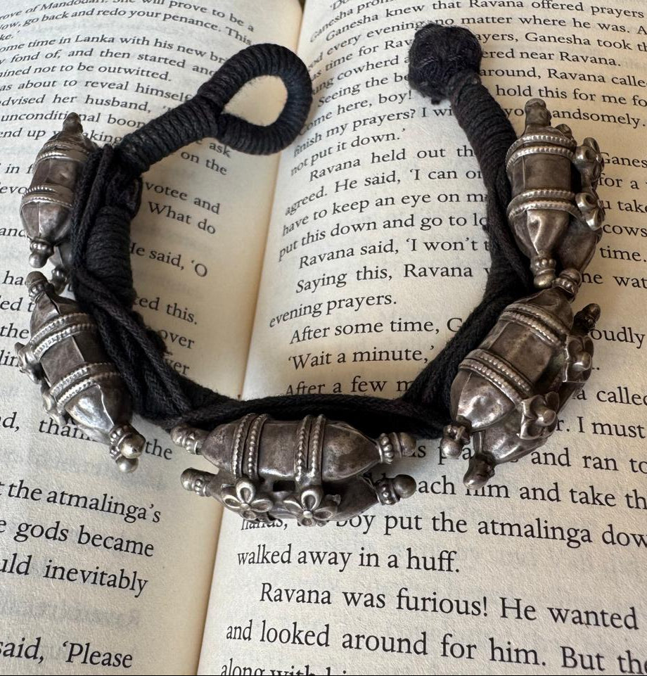 Bracelet with silver beads on an open book